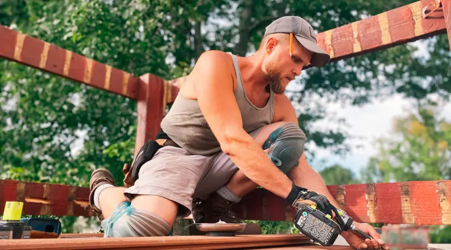 a man working hard building a deck physical work 2021 08 29 11 29 46 utc