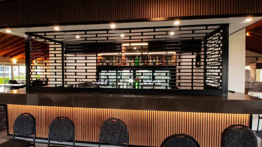 Black Knightguard Ultra motorised security grilles closed over the clubhouse bar at Akarana Golf Club, Mount Roskill, Auckland