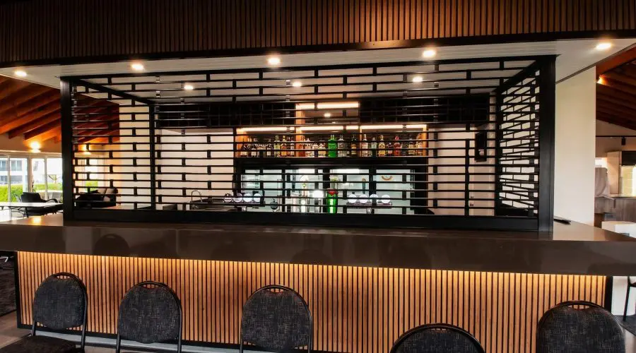 Black Knightguard Ultra motorised security grilles closed over the clubhouse bar at Akarana Golf Club, Mount Roskill, Auckland