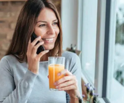 Woman relaxing by a window in a warm home fitted with double glazing