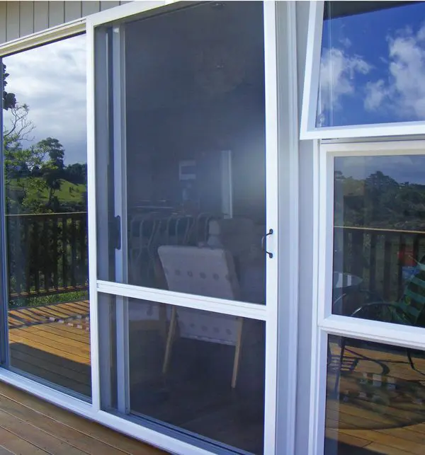 Sliding insect screen door opening onto a timber deck at an Auckland home